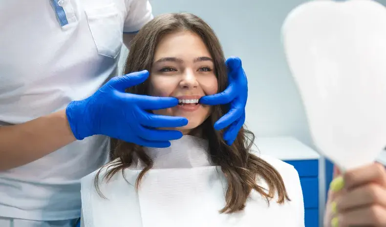 patient seeing her new smile at the dentist